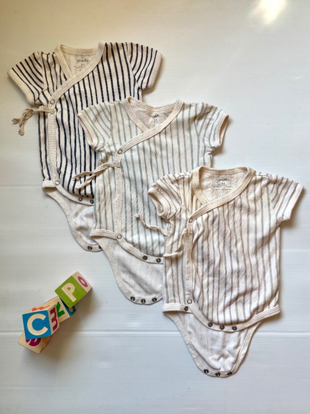 Three Petit Pehr short-sleeve organic cotton striped onesies - 0-3 months